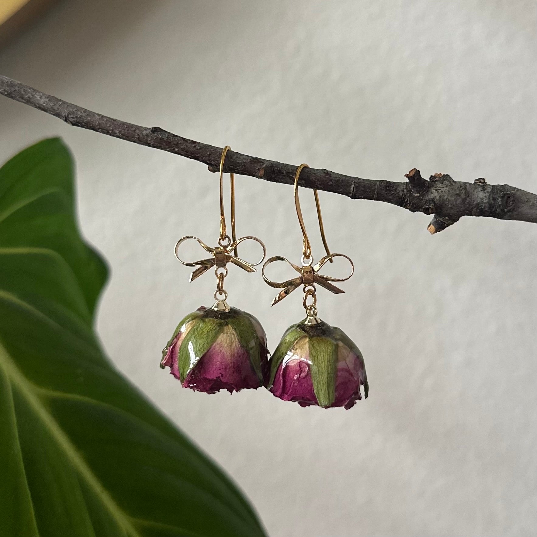 real rose bud earrings with gold bow accent, handcrafted