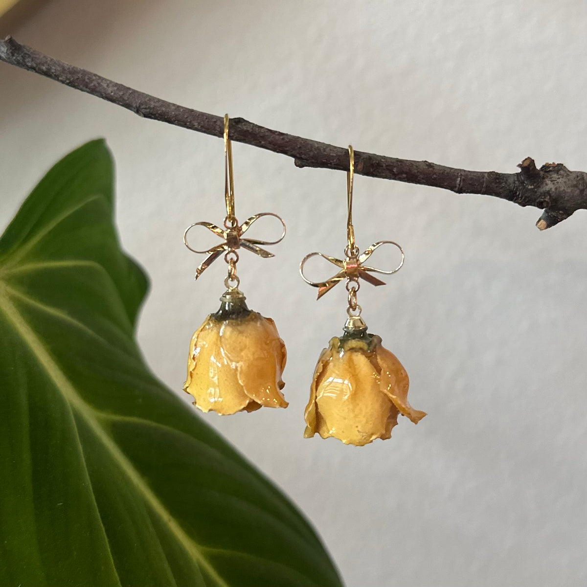 real rose bud earrings with gold bow accent, handcrafted