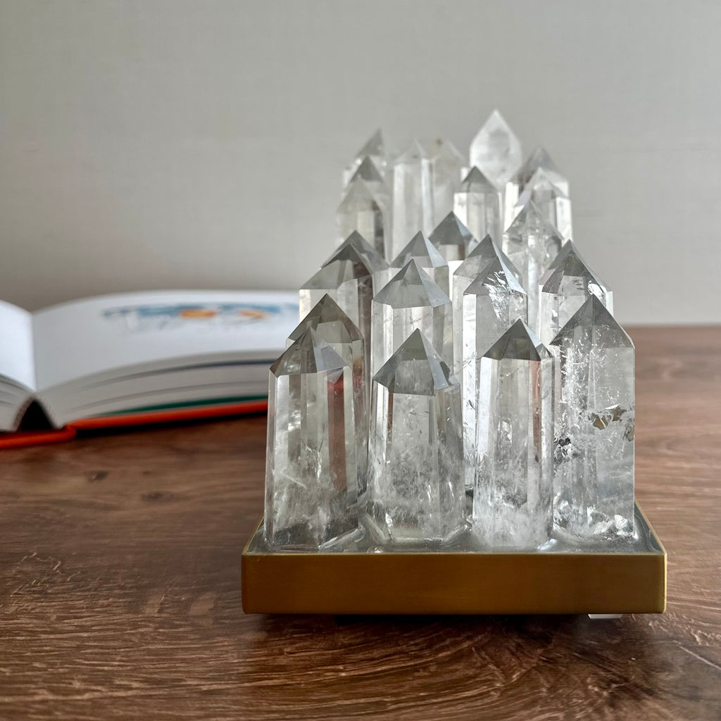 Clear quartz crystal lamp on brushed brass base with LED light