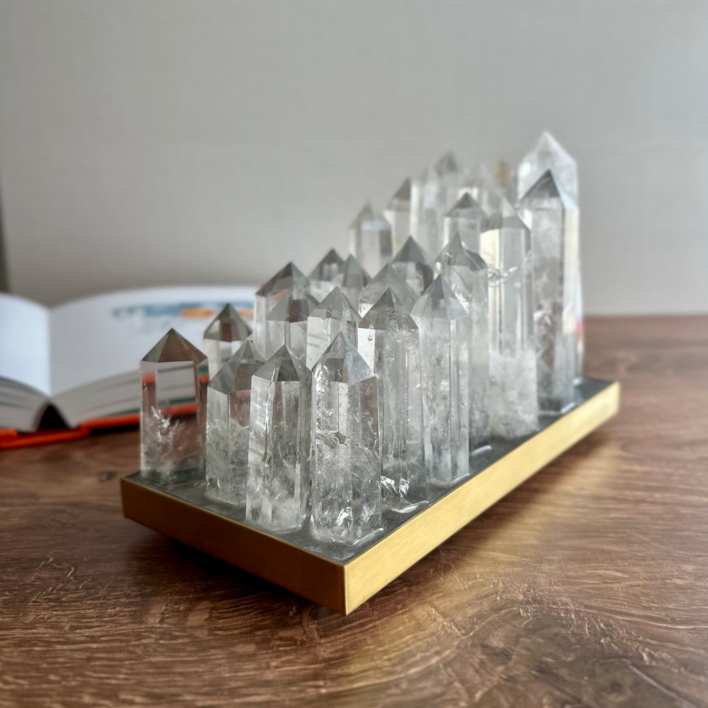 Clear quartz crystal lamp on brushed brass base with LED light