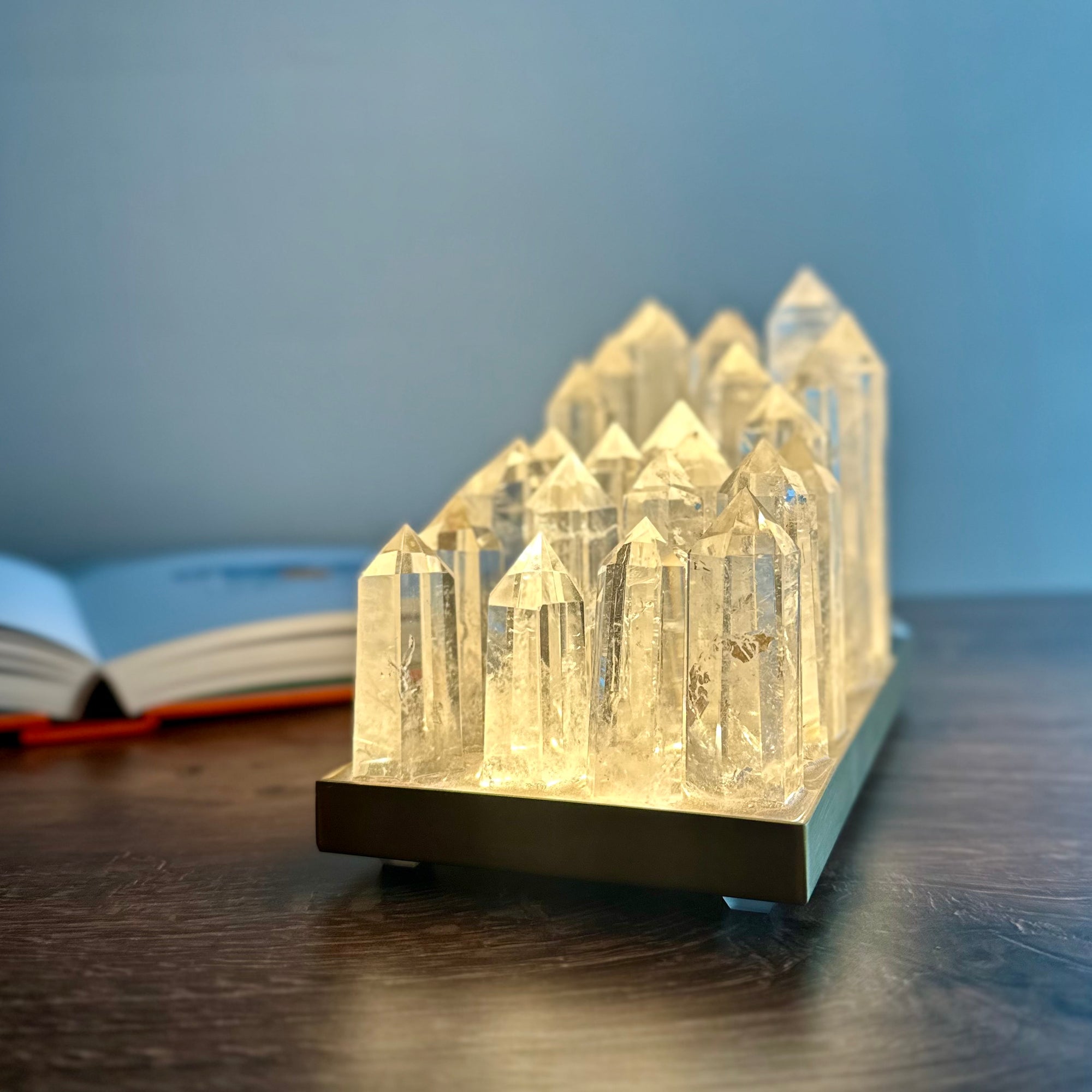 Clear quartz crystal lamp on brushed brass base with LED light