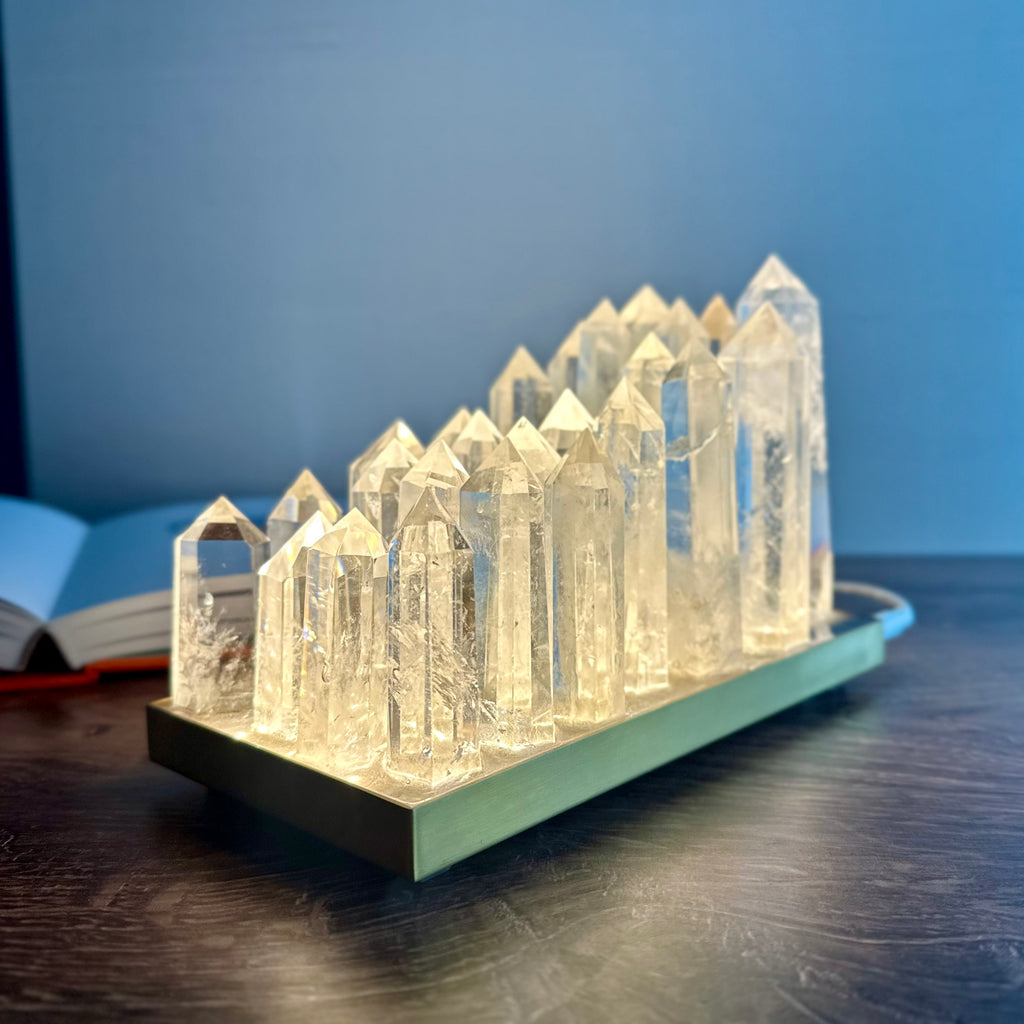 Clear quartz crystal lamp on brushed brass base with LED light