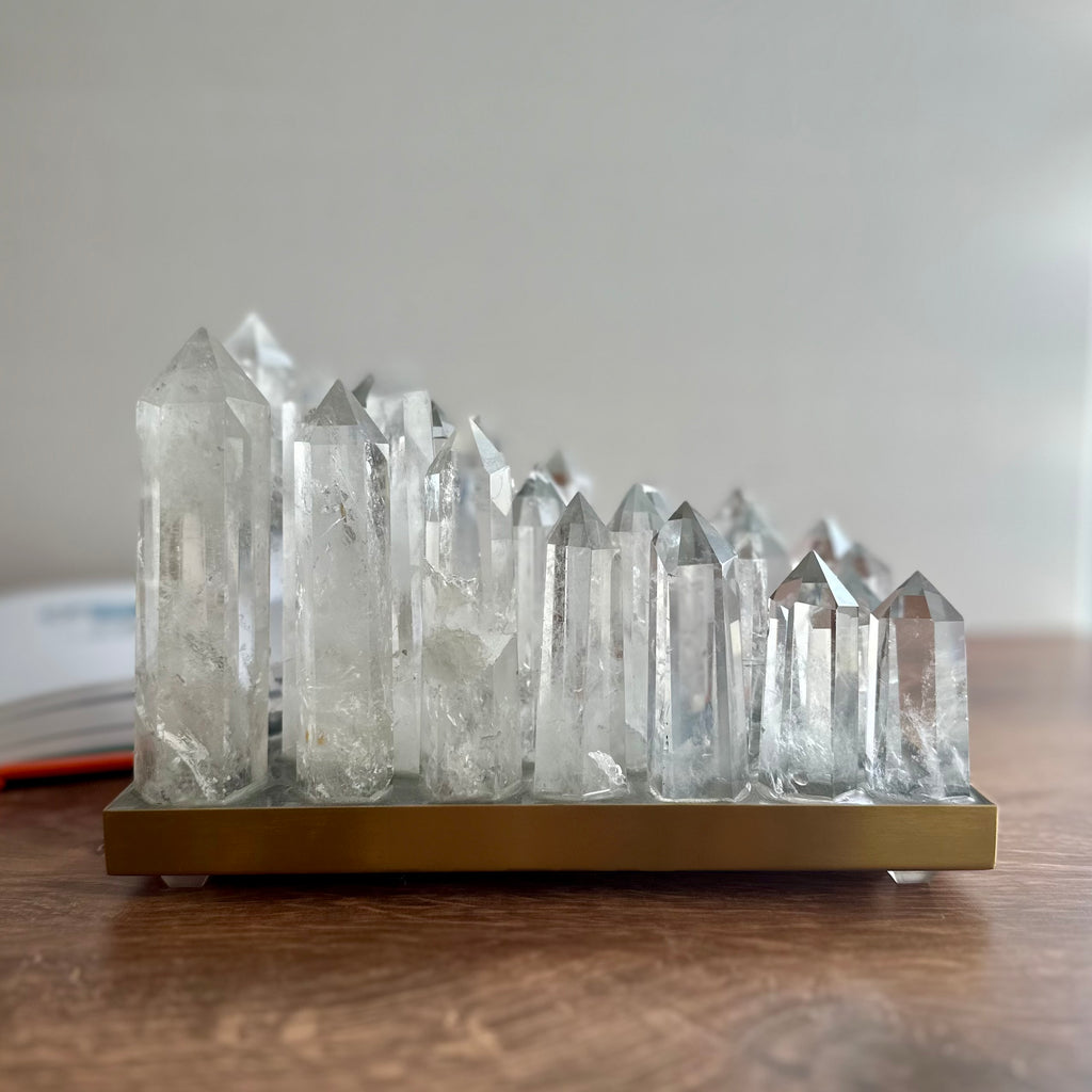 Clear quartz crystal lamp on brushed brass base with LED light