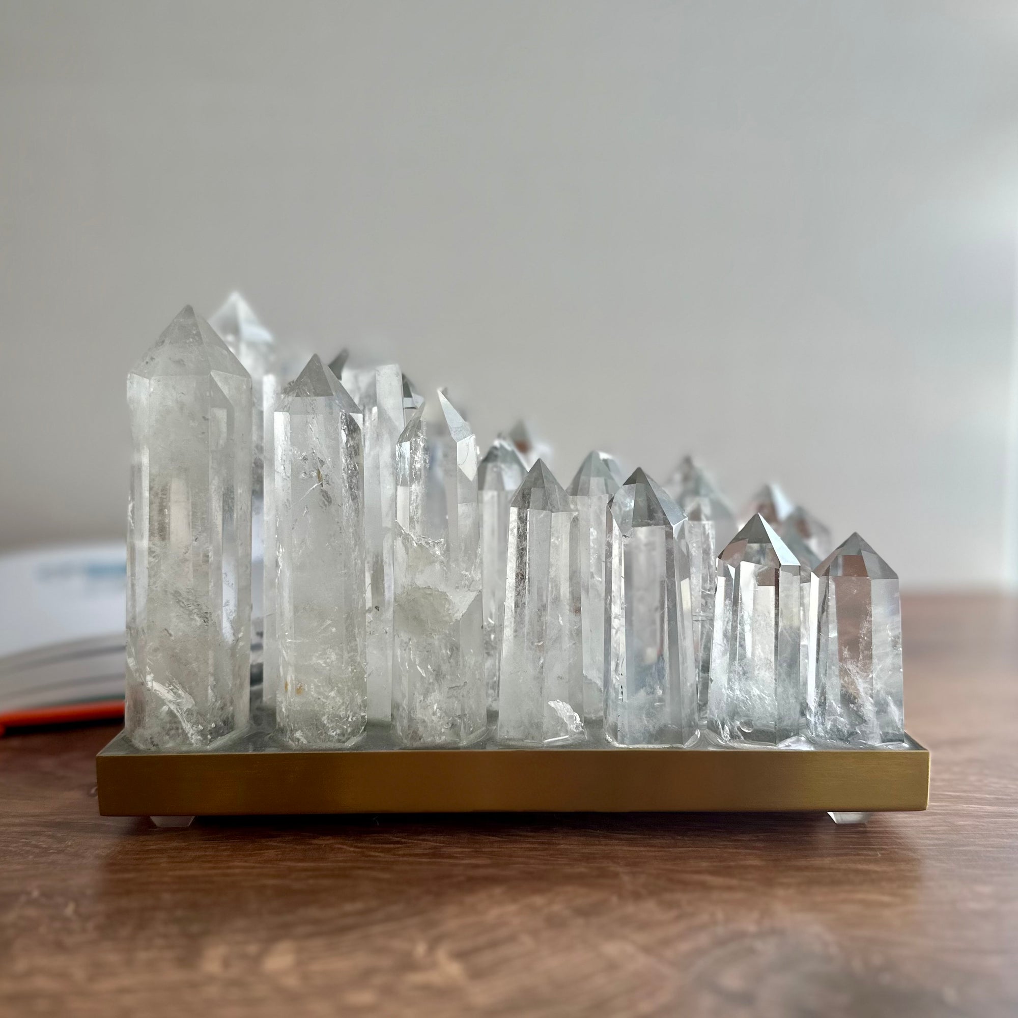 Clear quartz crystal lamp on brushed brass base with LED light